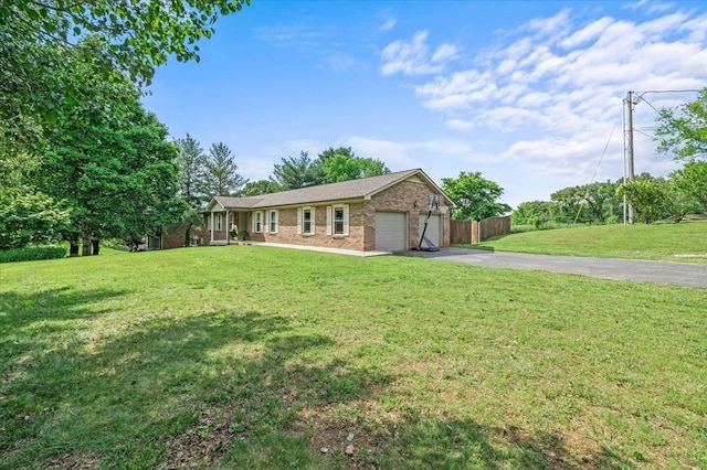 ranch-style house featuring a front lawn and a garage