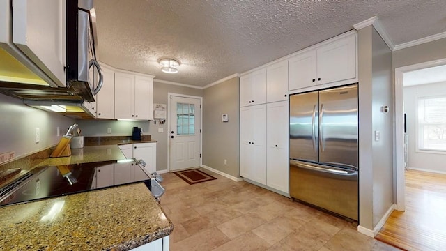 kitchen featuring stainless steel built in fridge, white cabinetry, and crown molding