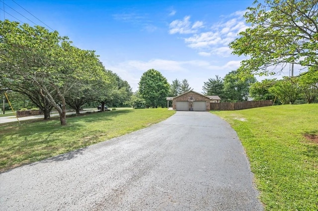 view of front of home with a front lawn and a garage