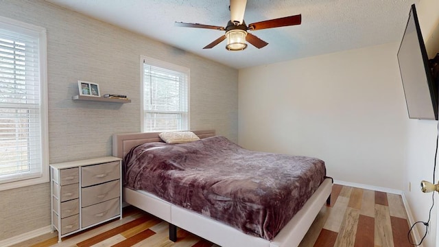 bedroom with light wood-type flooring and ceiling fan