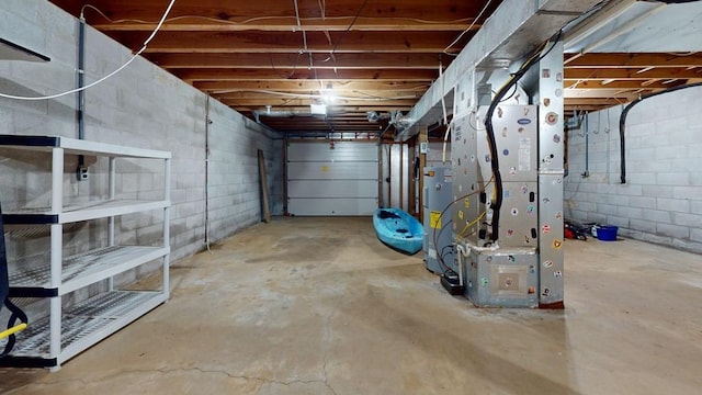 garage featuring heating unit and water heater