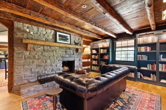 living room with a fireplace, wood-type flooring, wooden ceiling, and beamed ceiling