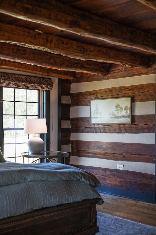 unfurnished bedroom with hardwood / wood-style floors, beam ceiling, and wood ceiling