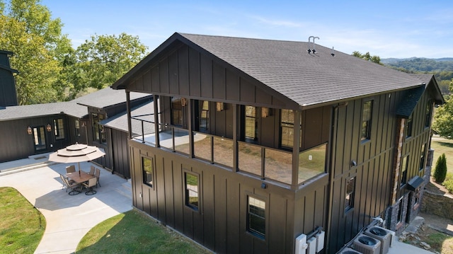 rear view of house featuring a balcony and a patio