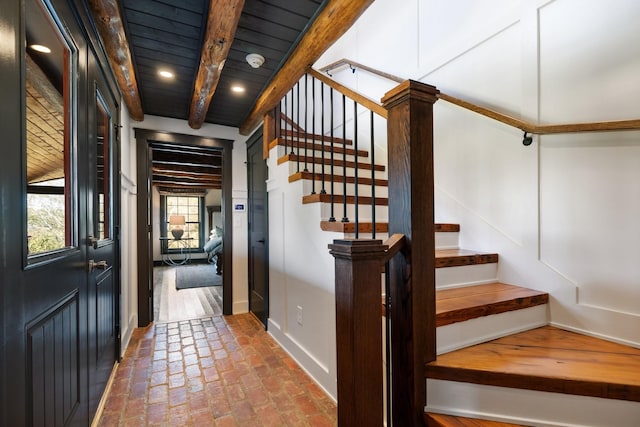 interior space featuring beamed ceiling and wooden ceiling