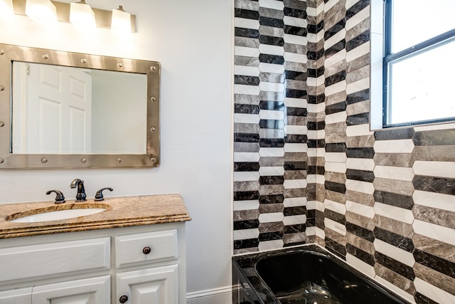 bathroom with vanity and a bath