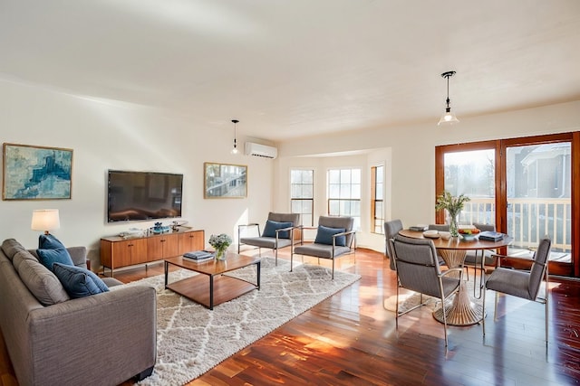 living room featuring wood-type flooring and a wall mounted air conditioner