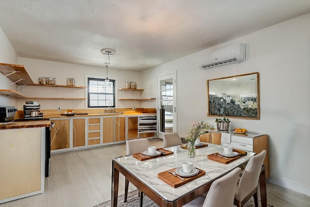 dining room with a wall mounted air conditioner and sink