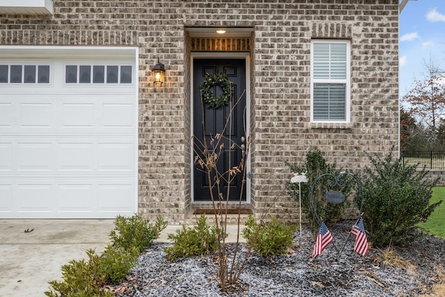 view of exterior entry with a garage