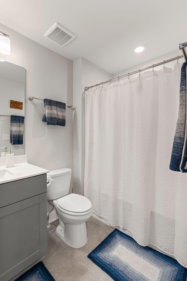 bathroom with tile patterned floors, vanity, and toilet