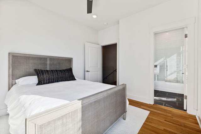 bedroom featuring ensuite bath, ceiling fan, and hardwood / wood-style floors