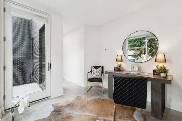 living area with concrete floors