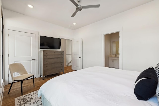 bedroom with ceiling fan, sink, ensuite bathroom, and hardwood / wood-style flooring