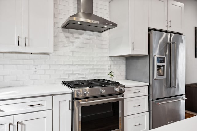 kitchen with white cabinetry, wall chimney range hood, stainless steel appliances, and tasteful backsplash