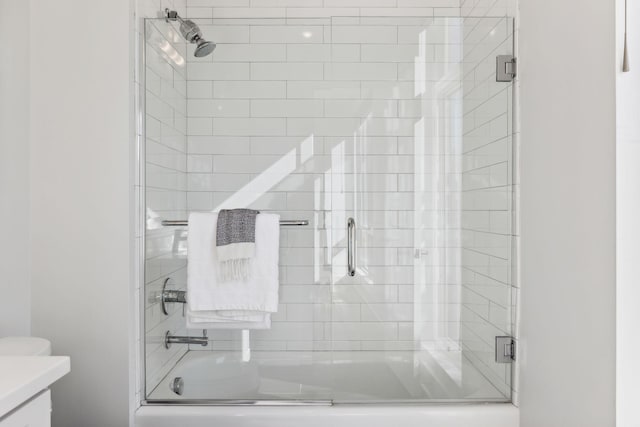 bathroom featuring shower / bath combination with glass door