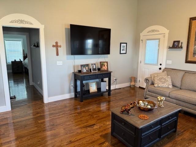 living room featuring dark wood-style floors and baseboards