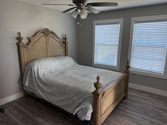 bedroom featuring ceiling fan, baseboards, and dark wood-type flooring