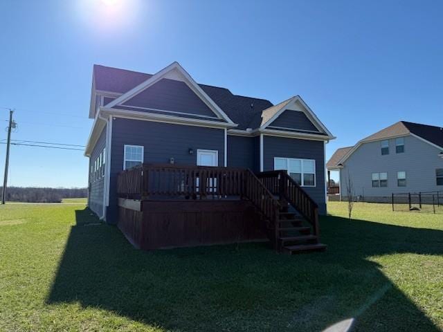 back of property with stairs, a yard, and a wooden deck