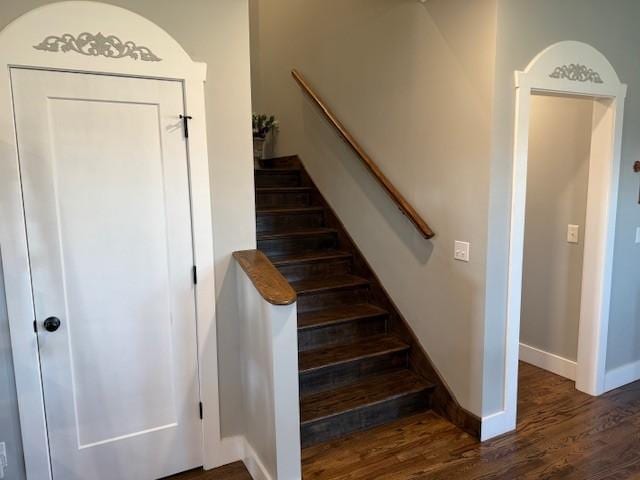 stairs with wood finished floors and baseboards