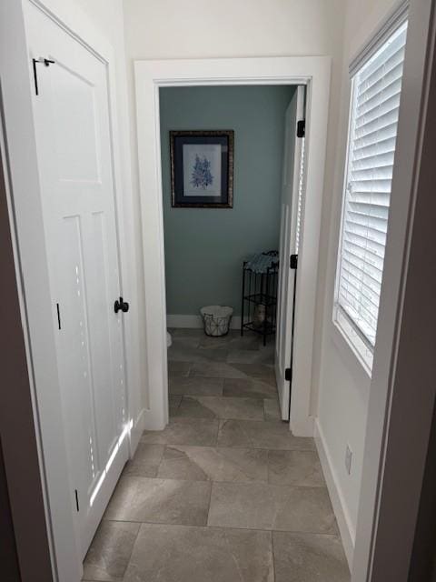 hallway featuring baseboards