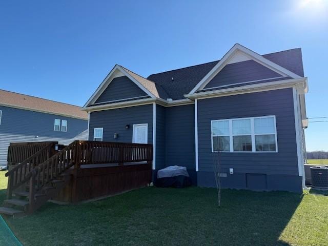 back of house with stairs, a lawn, a wooden deck, and central air condition unit