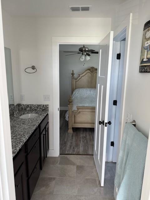 bathroom featuring vanity, visible vents, a ceiling fan, and ensuite bathroom