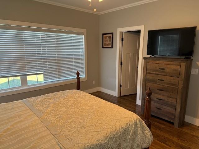 bedroom featuring ornamental molding, dark wood-style flooring, and baseboards