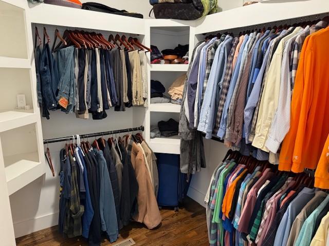 walk in closet with wood finished floors