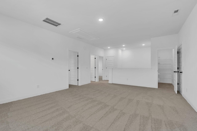 unfurnished room featuring light carpet