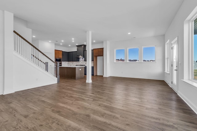 unfurnished living room featuring dark wood-type flooring