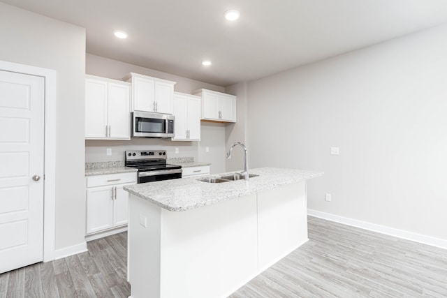 kitchen with white cabinetry, sink, a center island with sink, and appliances with stainless steel finishes