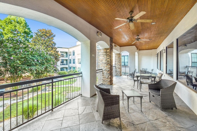 view of patio / terrace featuring ceiling fan and a balcony