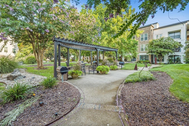 view of home's community featuring a yard and a pergola