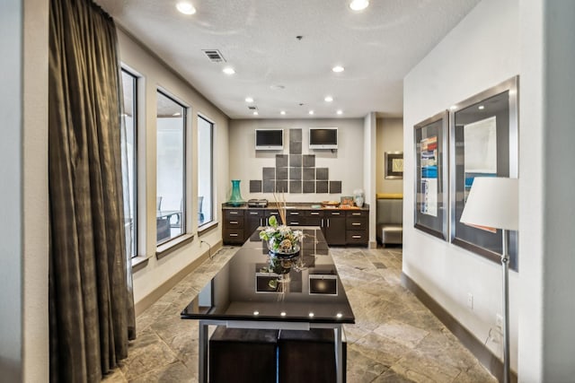 kitchen with a center island and dark brown cabinetry