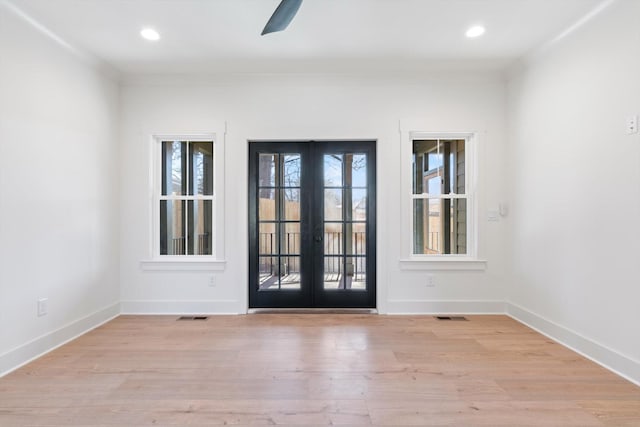 doorway to outside with visible vents, plenty of natural light, french doors, and light wood-style floors