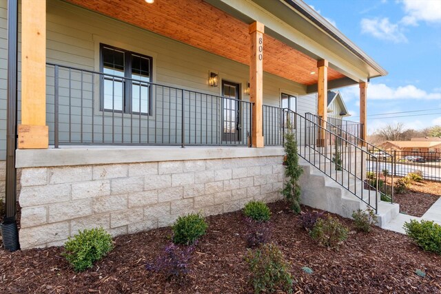 view of side of property featuring a porch