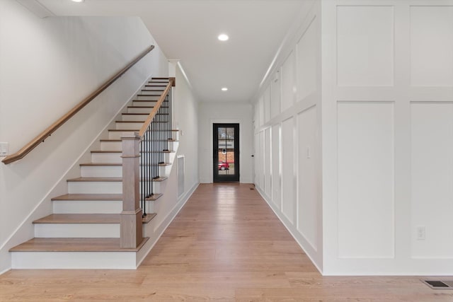 foyer with stairs, recessed lighting, visible vents, and light wood-type flooring