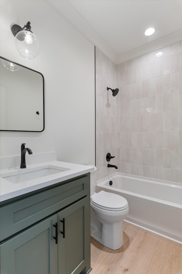 full bath with vanity, toilet, wood finished floors, and shower / bathtub combination