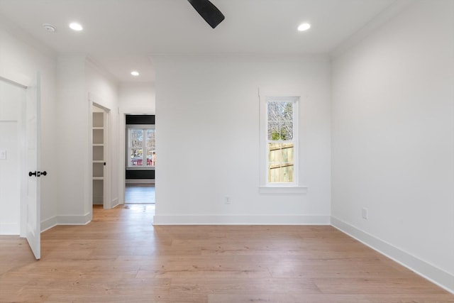 empty room featuring recessed lighting, baseboards, and light wood finished floors