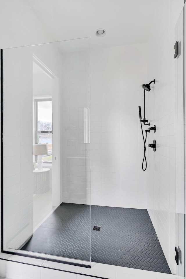 bathroom featuring a shower with door