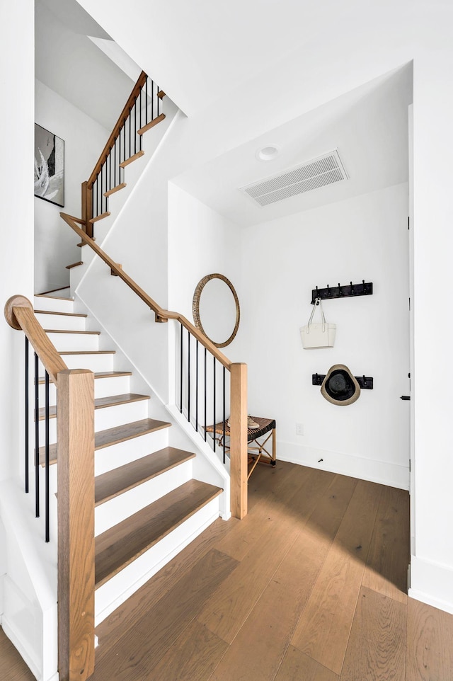 staircase featuring hardwood / wood-style flooring