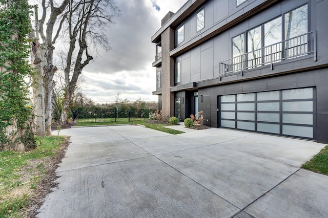 view of home's exterior with a balcony and a garage