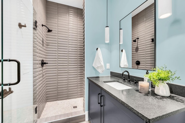 bathroom featuring vanity and a shower with shower door