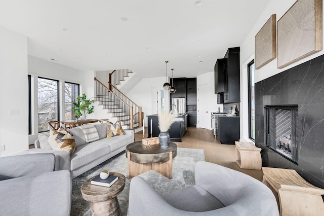 living room with light wood-type flooring and a premium fireplace