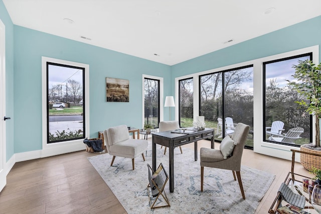 home office with light hardwood / wood-style floors