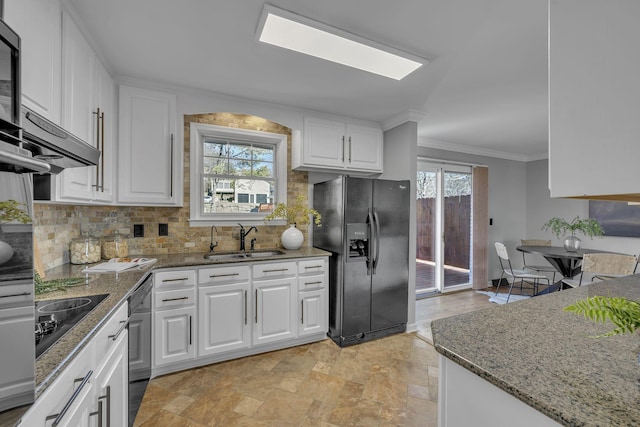 kitchen with stone countertops, sink, white cabinetry, and black appliances