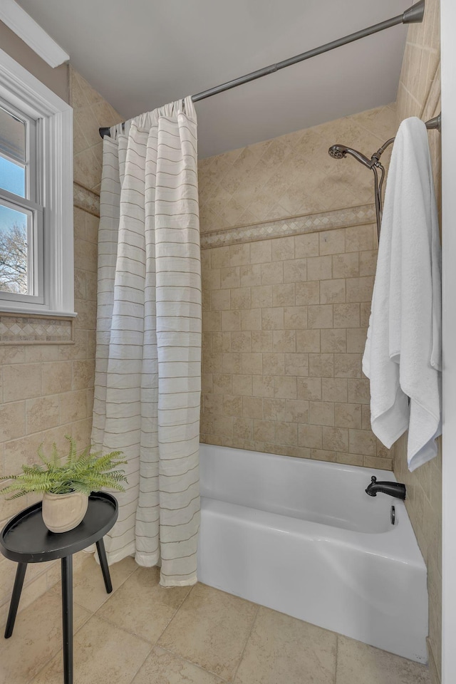 bathroom with tile patterned floors and shower / bath combo with shower curtain