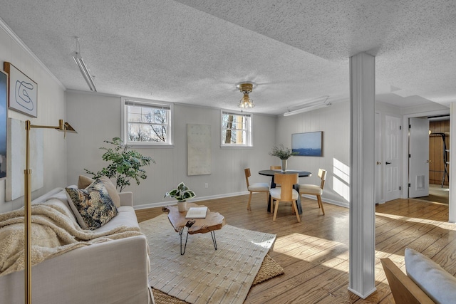 living room featuring hardwood / wood-style floors and crown molding