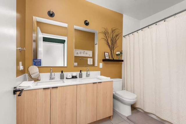 bathroom with tile patterned flooring, vanity, and toilet