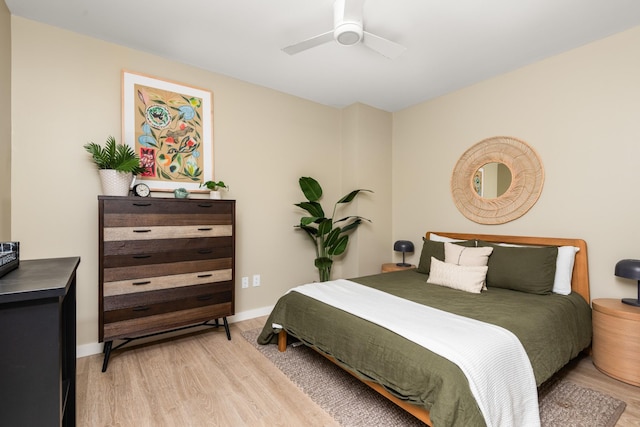 bedroom with light hardwood / wood-style floors and ceiling fan